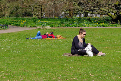 People sitting on grassy field