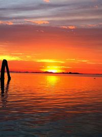 Scenic view of sea against orange sky