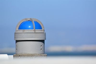 Close-up of metallic structure against sea