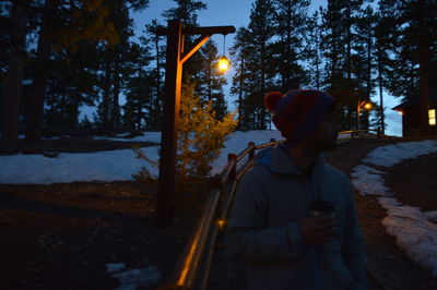 Rear view of man in snow at night