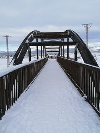 Bridge covered with snow against sky