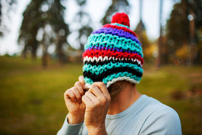 Close-up of funny man wearing hat in autumn forest