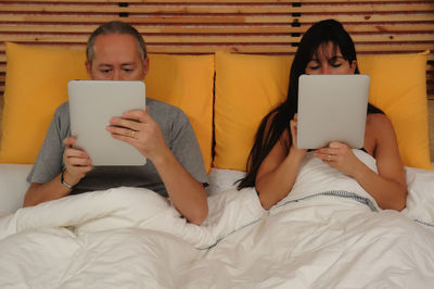 Couple in bed with a tablet