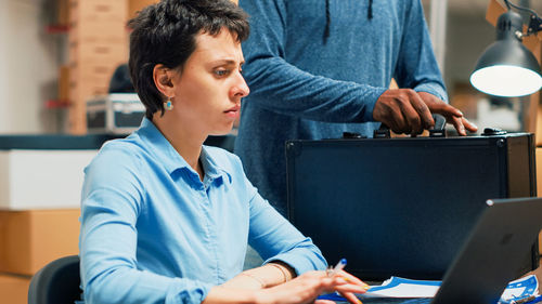 Young woman using laptop at office