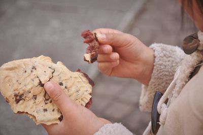 Midsection of person holding taiyaki cake