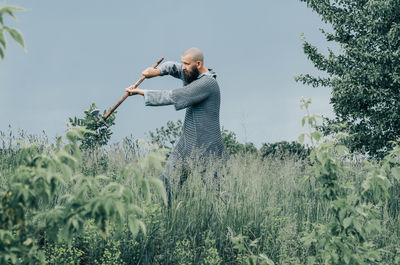 Viking warrior man with ax in emotional pose. historical photo concept