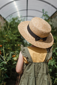 Rear view of man holding hat