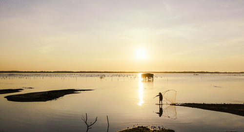 Scenic view of lake against sky during sunset