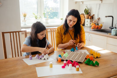 Mother and son on table