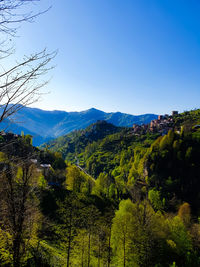 Scenic view of mountains against clear blue sky