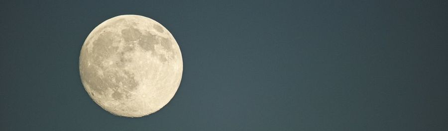 Low angle view of moon against clear sky at night