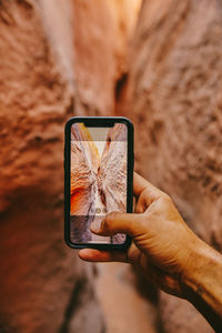 Taking picture with phone of narrow slot canyons in escalante, utah