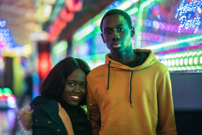 Portrait of young couple standing outdoors