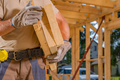 Midsection of man working in factory