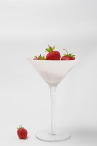 Close-up of fruits on table against white background