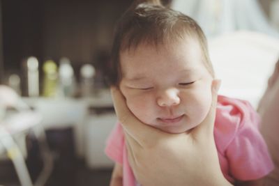 Close-up portrait of cute baby at home