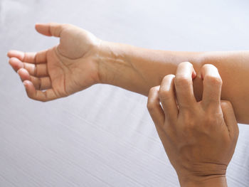 Close-up of woman hand over white background