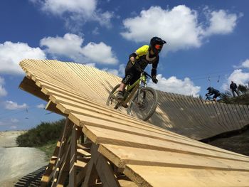 Man riding bicycle against sky