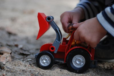 Close-up of hand holding toy car