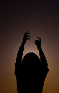 Silhouette man against clear sky during sunset