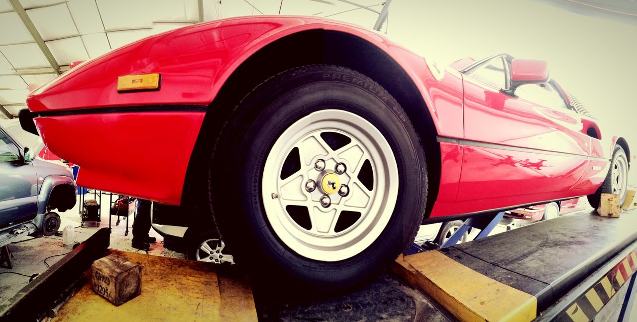 tire, transportation, car, red, land vehicle, wheel, mode of transport, day, no people, outdoors, auto repair shop, close-up