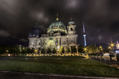 Illuminated berlin dome against sky at night