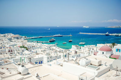 High angle view of city by sea against sky