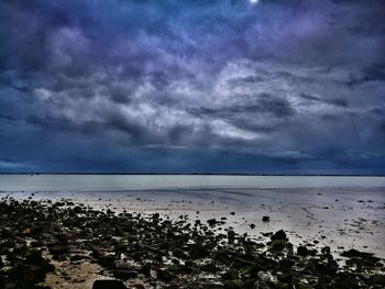 Scenic view of sea against dramatic sky