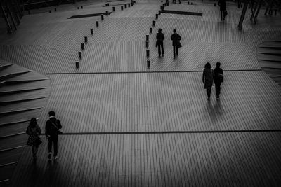 High angle view of silhouette people walking on footpath