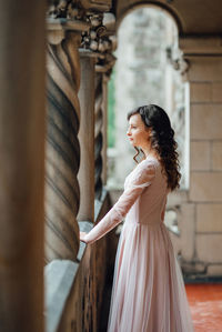 Side view of a young woman looking at camera