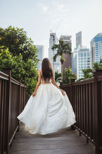 This captivating photograph features a stunning asian woman in a unique white wedding