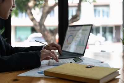 Midsection of business colleagues working at table