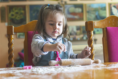 Cute girl making cookie at home