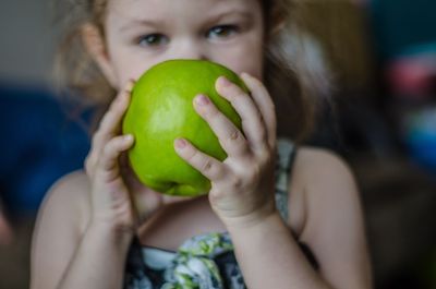 Close-up of girl holding apple