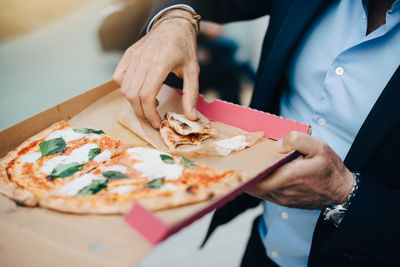 Midsection of man preparing food in restaurant