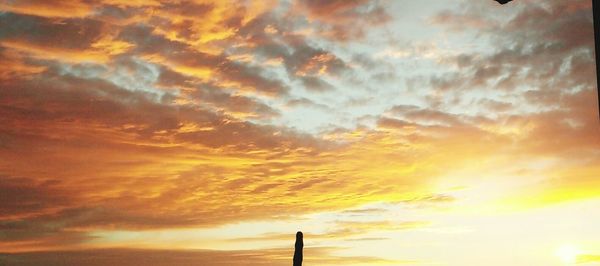 Low angle view of cloudy sky at sunset