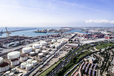 High angle view of city by sea against sky