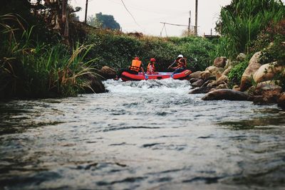 People on inflatable raft in river