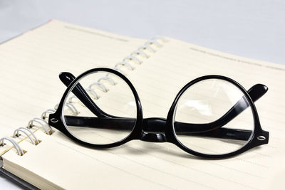 Close-up of eyeglasses on book