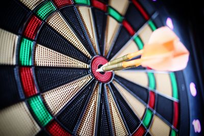 Close-up of arrow on dart board