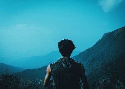 Rear view of man looking at mountains