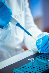 Midsection of scientist working at laboratory