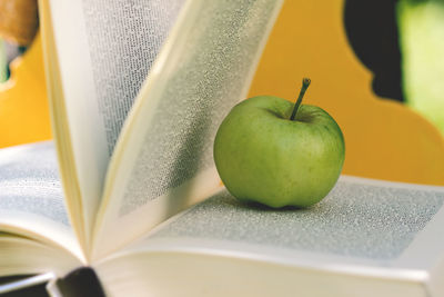 Close-up of apple on book