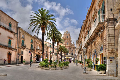 Street amidst buildings in city against sky