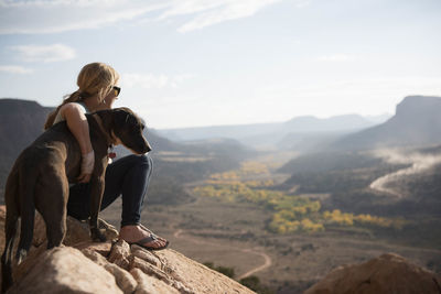 A woman and her dog enjoying the desert views, utah