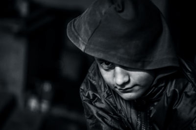 Close-up portrait of teenage boy wearing hooded shirt