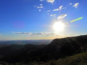 Scenic view of mountains against bright sun