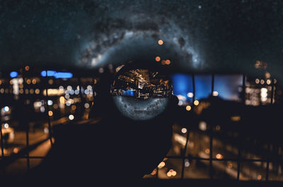 Close-up of illuminated cityscape against sky at night