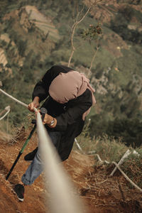 High angle view of woman hiking on mountain