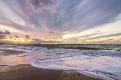 Scenic view of beach against sky during sunset